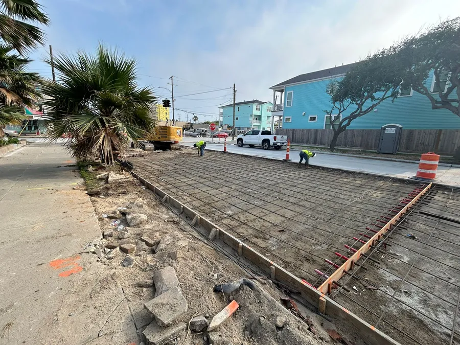 Concrete site preparation with reinforcing steel and formwork.